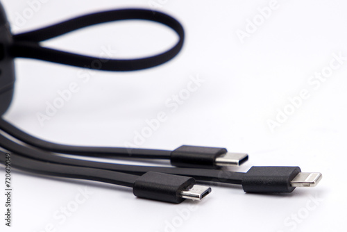 black power bank for charging with three usb cables attached