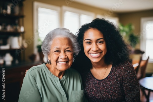 Senior woman with caregiver smiling at home