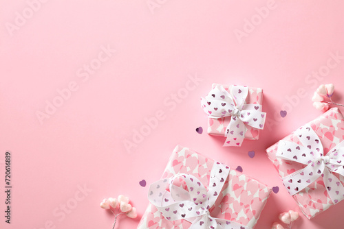 Valentine's Day flat lay composition with Valentines gifts and decorations on pink background.