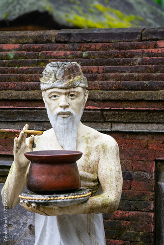 Balinese stone sculpture in front of a temple