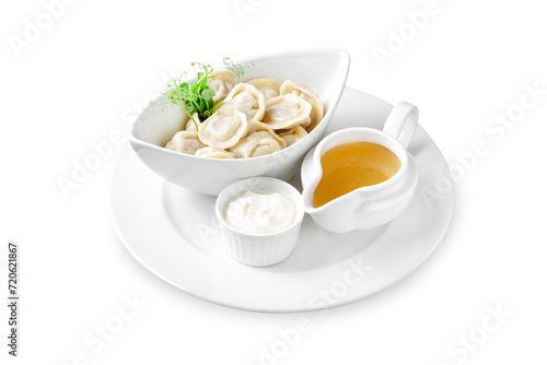 Siberian dumplings with meat, sour cream and broth. Lunch. Isolated.