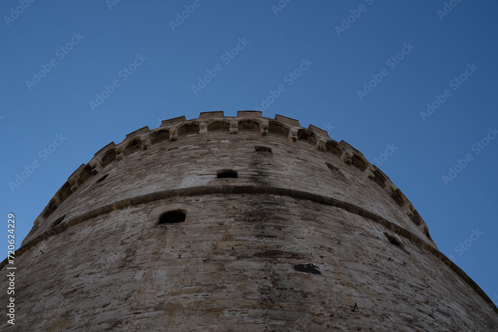 Famous building architecture, White tower, shot from low angle perspective. Part of greek history. Popular, tourist destination. Famous building architecture, White tower, shot from low angle perspective. Part of greek history. Popular, tourist destination.