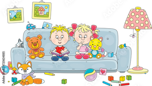 Happy little boy and girl among their funny toys reading an interesting children’s book with pictures on a sofa in a nursery playroom, vector cartoon illustration isolated on a white background