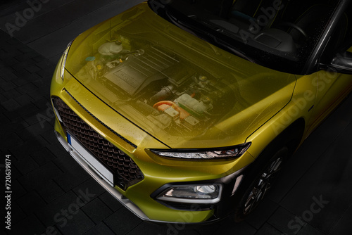 The idea of showing a hybrid engine under the hood of a car. The engine is visible through the translucent hood.