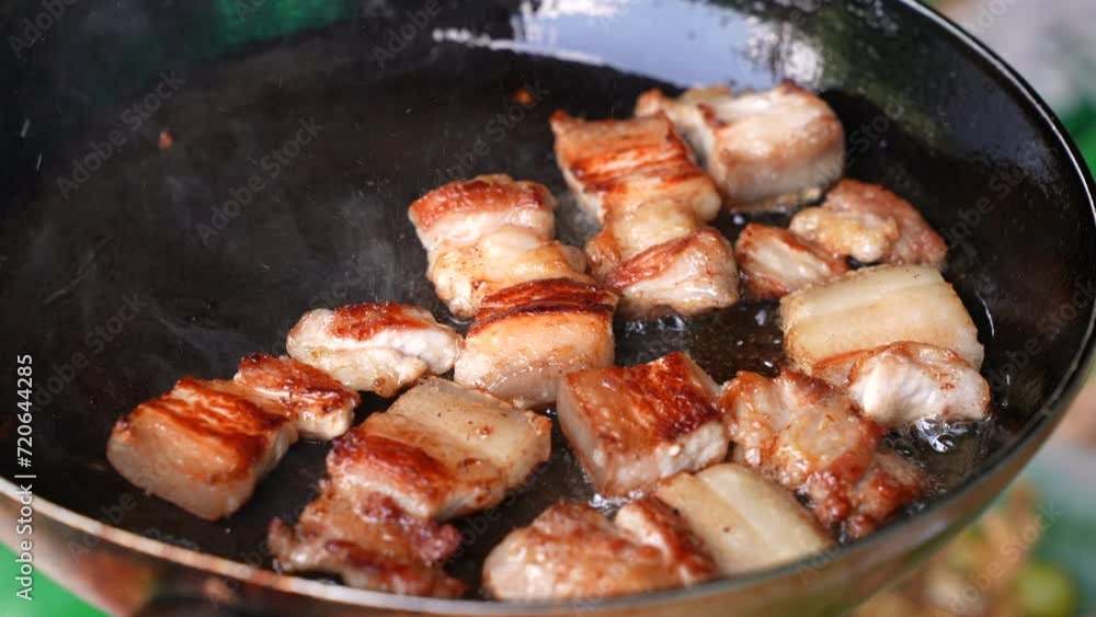 Pork belly pieces fried on a pan Pork belly pieces fried on a pan
