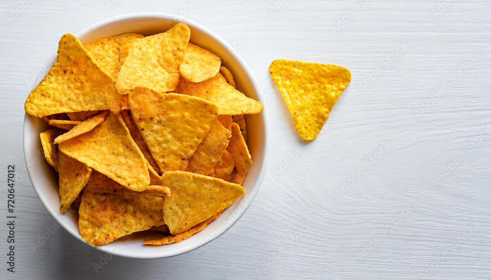 Corn chips nachos on white bowl, isolated on white background, copyspace on a side