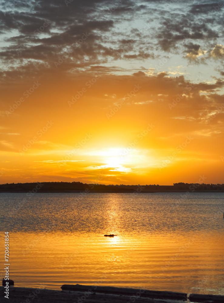 Golden hour on lake with beautiful cloud silhouettes