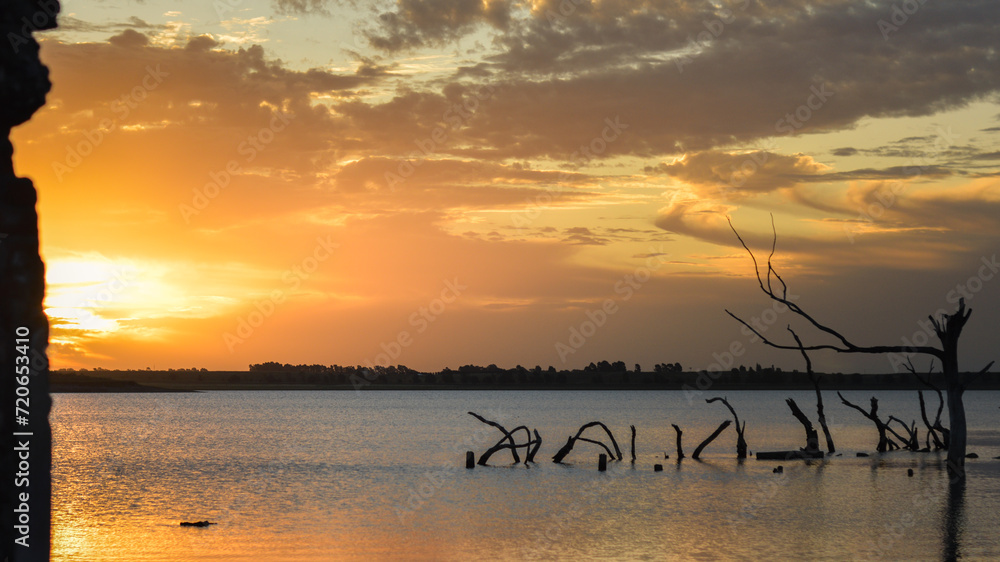 Golden hour on lake with beautiful cloud silhouettes