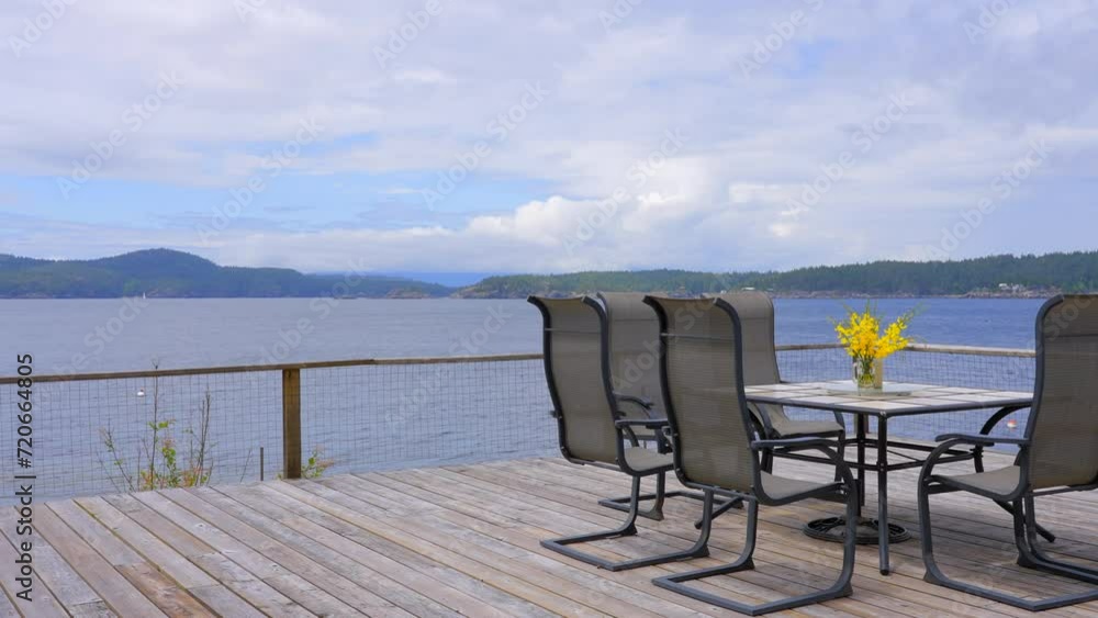Establishing shot of empty balcony or veranda in a modern house with nice ocean and mountain view with blue sky and white clouds. Day time June 2019. ProRes 422 HQ. Establishing shot of empty balcony or veranda in a modern house with nice ocean and mountain view with blue sky and white clouds. Day time June 2019. ProRes 422 HQ.