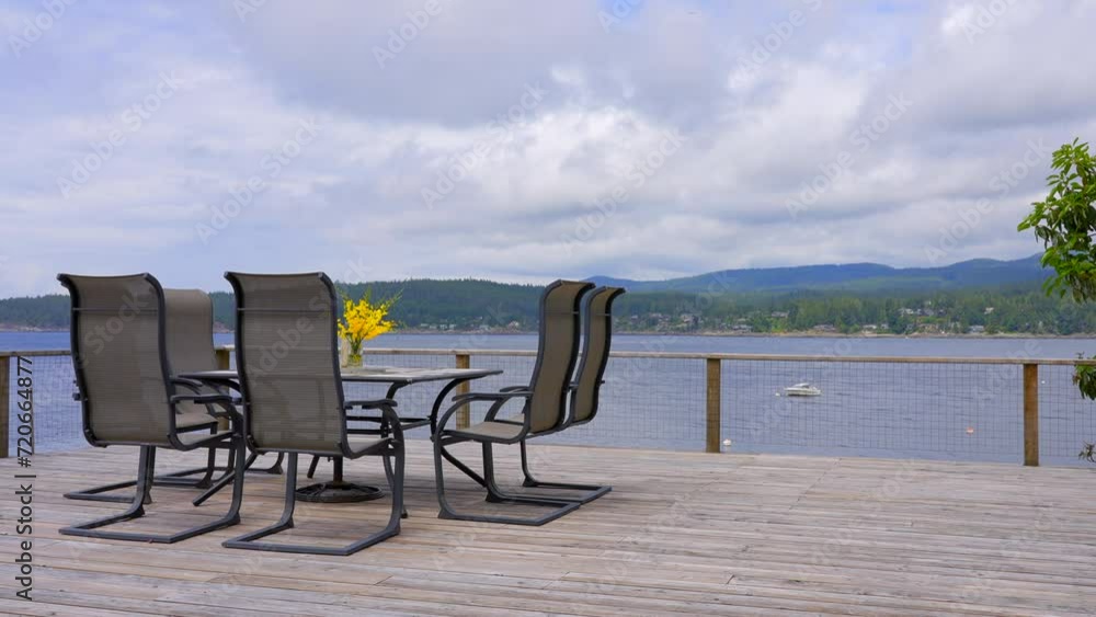 Establishing shot of empty balcony or veranda in a modern house with nice ocean and mountain view with blue sky and white clouds. Day time June 2019. ProRes 422 HQ. Establishing shot of empty balcony or veranda in a modern house with nice ocean and mountain view with blue sky and white clouds. Day time June 2019. ProRes 422 HQ.