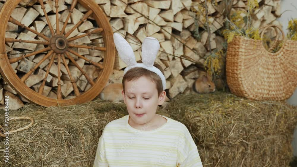 Charming boy with fluffy ears sneezes and wipes his snot with hand