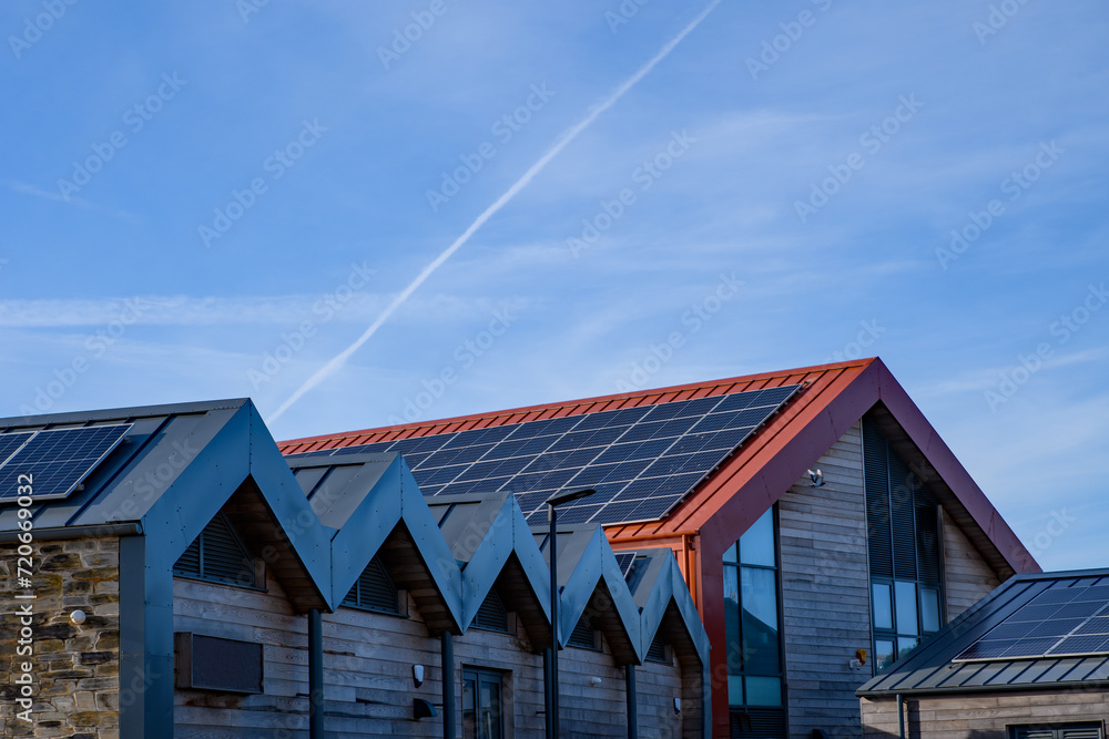 Energy and power, solar panels, roof mounted on a sunny day. Renewable energy saving, harnessing concept. Energy and power, solar panels, roof mounted on a sunny day. Renewable energy saving, harnessing concept.