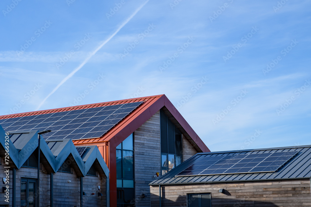 Energy and power, solar panels, roof mounted on a sunny day. Renewable energy saving, harnessing concept. Energy and power, solar panels, roof mounted on a sunny day. Renewable energy saving, harnessing concept.