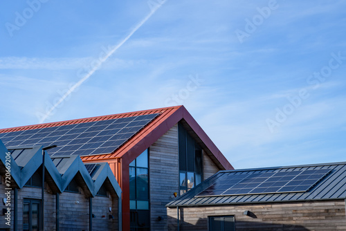 Energy and power, solar panels, roof mounted on a sunny day. Renewable energy saving, harnessing concept.