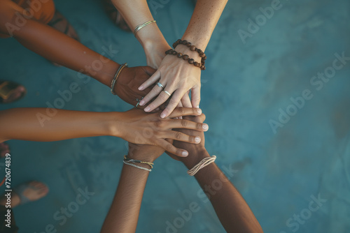 Team putting their hands on the center. Diverse group hands together. Team unity with cultural blend. People gathering in a symbolic center, showcasing teamwork, diversity, and cultural richness.
