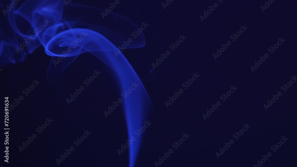 Smoke incense stick close-up on a dark background Smoke incense stick close-up on a dark background