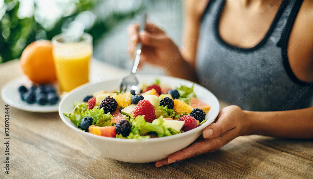 female athlete enjoys a vibrant fruit salad, embodying health, wellness, and the joy of nourishing her body with wholesome nutrition