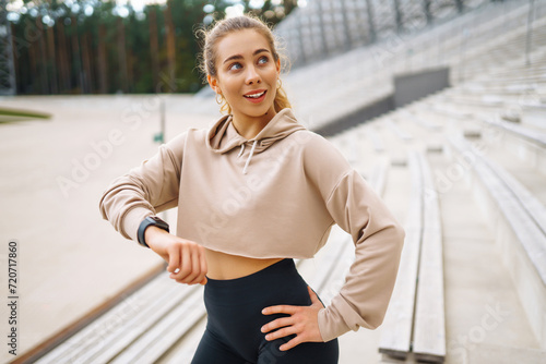 Young woman with smart watch goes in for sports  performs sport exercises. Sport  Active life  sports training  healthy lifestyle.