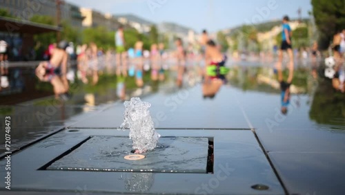 Jet of water in a fountain in a public park at the Massena square photo