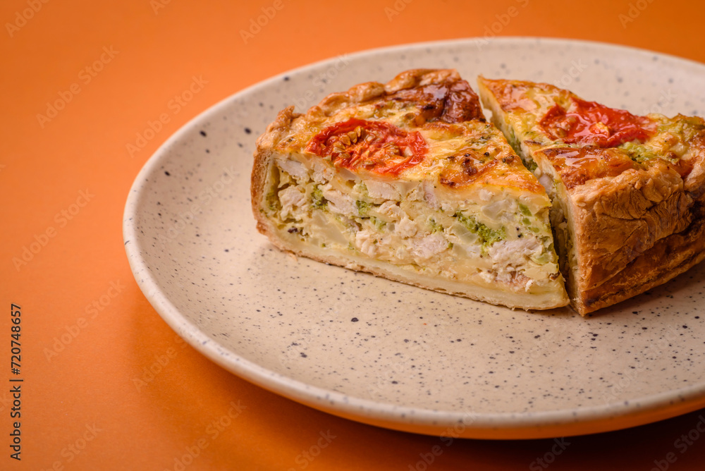 Delicious quiche with tomato, cheese, chicken, spices and herbs