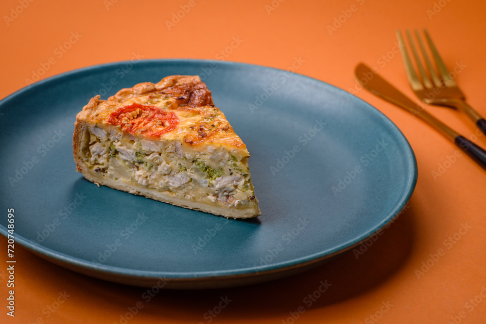 Delicious quiche with tomato, cheese, chicken, spices and herbs