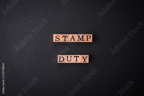 The inscription Stamp Duty made of wooden cubes on a plain background photo