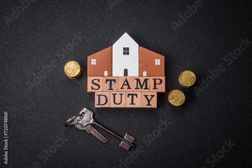 The inscription Stamp Duty made of wooden cubes on a plain background photo