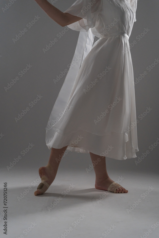 legs of a ballerina in a white dress legs of a ballerina in a white dress