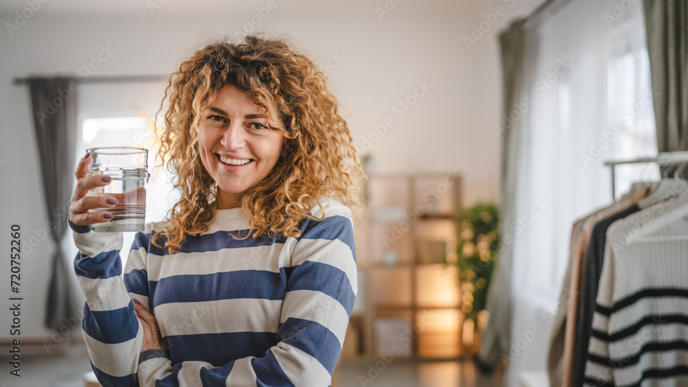 one woman beautiful young female at home with glass of water one woman beautiful young female at home with glass of water