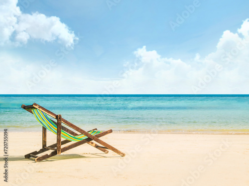 Lounge chairs on a tropical beach at summer © Acronym