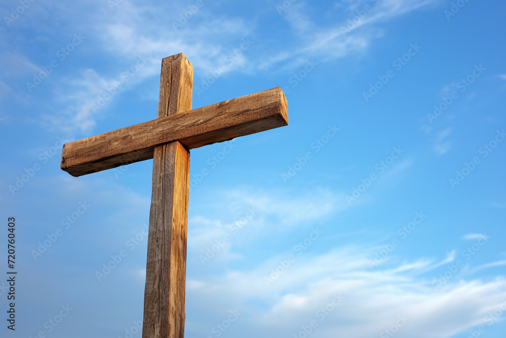 Wooden Christian cross against a blue sky Wooden Christian cross against a blue sky