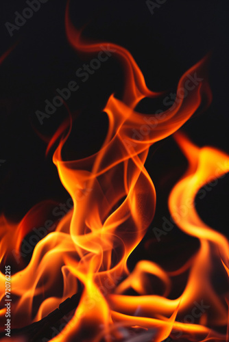 Orange flames, fire in front of a black background