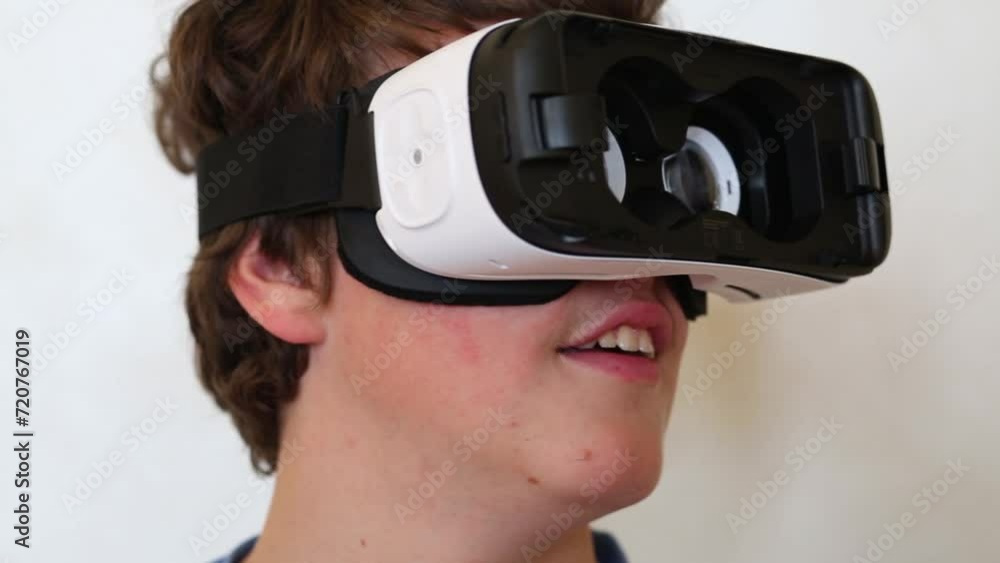 Boy in glasses of virtual reality without the lid turns his head Boy in glasses of virtual reality without the lid turns his head
