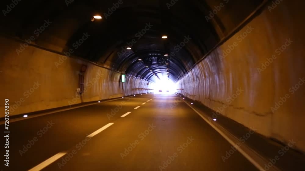 Movement through the long tunnel on the two-lane road Movement through the long tunnel on the two-lane road