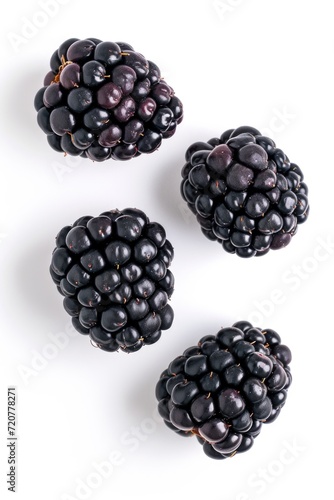 A group of blackberries arranged neatly on a white surface. Perfect for food photography or healthy eating concepts