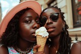 Two young women enjoying ice cream cones. Ideal for lifestyle and summer-themed designs