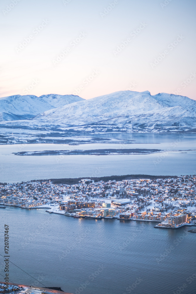 Fjellheisen viewpoint over tromso city in north of norway in winter time with the sunset over the fjords