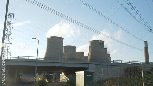 Thermal power plant in Ratcliffe On Soar with cooling towers and overhead power line. Massive industrial infrastructure for the production of electricity and its distribution over large distances. photo