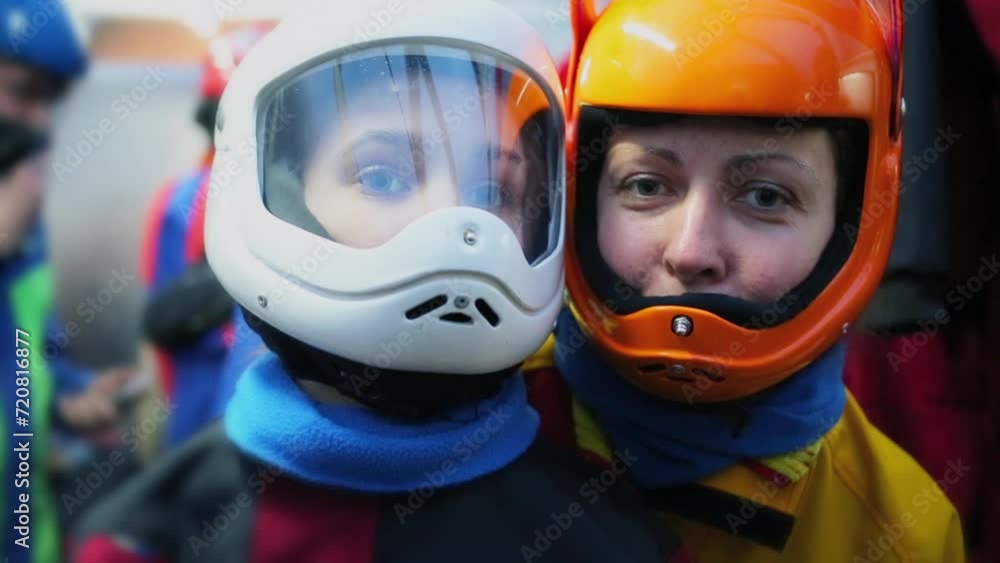Woman and young girl poses in helmets for air tube flying Woman and young girl poses in helmets for air tube flying