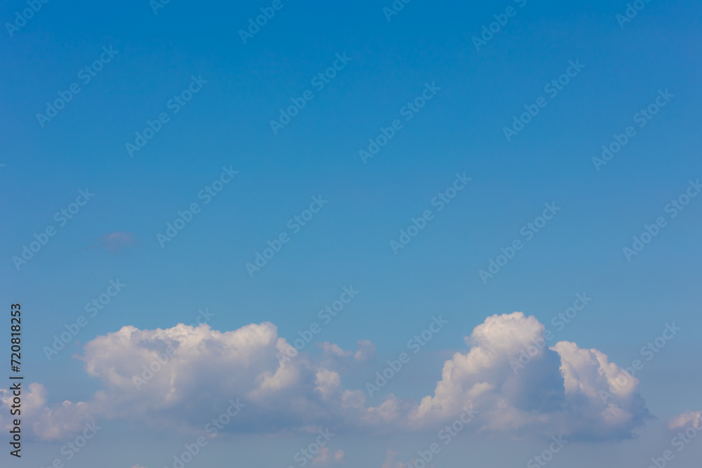 Beautiful white fluffy cloud floating in blue sky in sunny day, Cumulus are clouds which have flat bases and are often described as puffy, Horizon nature background with free copy space. Beautiful white fluffy cloud floating in blue sky in sunny day, Cumulus are clouds which have flat bases and are often described as puffy, Horizon nature background with free copy space.