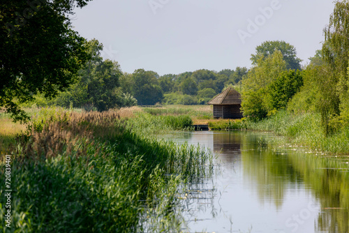 Summer landscape with water land and farmhouse, Typical countryside with canal or ditch, The Pieterpad is a long distance walking route in the Netherlands, The trail runs from Groningen to Maastricht.