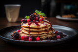 Stack of pancakes topped with fresh berries and syrup, food photo.