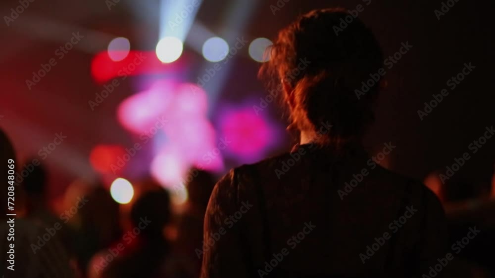 Woman dance near crowd of spectators during concert Woman dance near crowd of spectators during concert