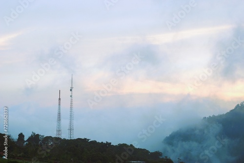 foggy mountain in the morning with communication tower