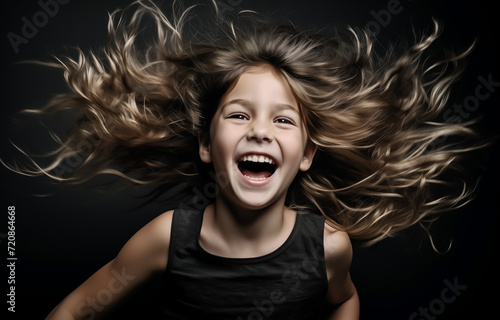Joyful child with flowing hair laughing heartily
