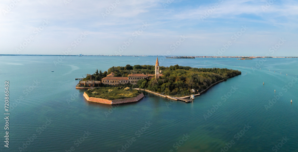Aerial view of the plagued ghost island of Poveglia in the Venetian lagoon, opposite Malamocco along the Canal Orfano near Venice, Italy.