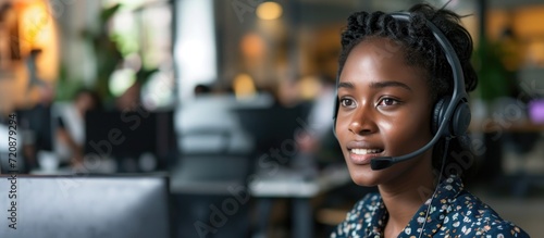 Black woman with headset in call center working with global telemarketing team photo