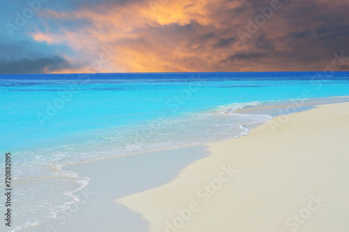 Fototapeta Naklejka Na Ścianę i Meble -  Waves on beach in Maldivian sea under dramatic sky