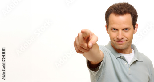 Portrait of a young man pointing at you, isolated on white background