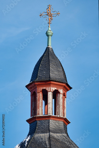 the spire of the historic cologne church alt st heribert with the weathered wooden construction of the bell tower in january 2024 photo